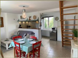 a kitchen and living room with a table and chairs at maison proche du lac in Châteauroux
