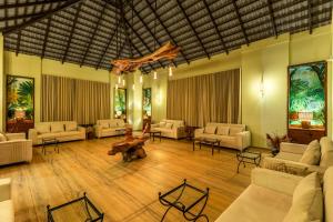 a large living room with white couches and tables at Sterling Tipeshwar in Pahāpal +47 photos
