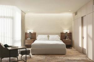 a bedroom with a bed and a desk and a chair at Lisbon Marriott Hotel in Lisbon