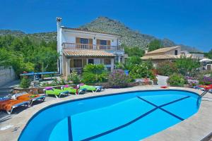 a swimming pool in front of a house at Villa Carla by Sealand Villas in Port de Pollensa