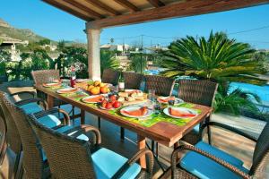 a table with fruits and vegetables on a patio at Villa Carla by Sealand Villas in Port de Pollensa