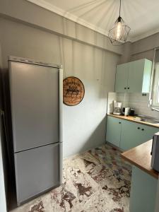 a kitchen with a refrigerator in the corner at Adrianos House by the sea in Iraklitsa