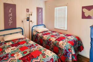 a bedroom with two beds and a comforter at Last Mango in Hatteras 191 in Avon +31 photos