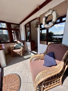 a patio with a chair and a life preserver at Your Lake side Retreat Sleeps 10-12 Nr Park & Sea in Poole