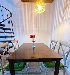 a table with a vase with a flower on it at Seafront Escape in Latchi in Polis Chrysochous