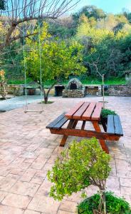a wooden picnic table sitting on a brick patio at Seafront Escape in Latchi in Polis Chrysochous +3 photos