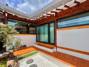 a modern house with glass doors and windows at Private house emotional accommodation, Hanok Stay Owol in Andong