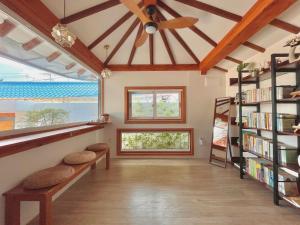a home library with benches and bookshelves at Private house emotional accommodation, Hanok Stay Owol in Andong