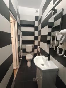 a black and white bathroom with a toilet and a sink at M20 Studios in Cluj-Napoca +48 photos