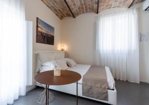 a white bedroom with a bed and a table at Boutique Room Santa Maria by Il Timbro in Vasto +7 photos
