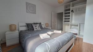 a bedroom with a bed with two towels on it at Les Nids de Montluçon in Montluçon