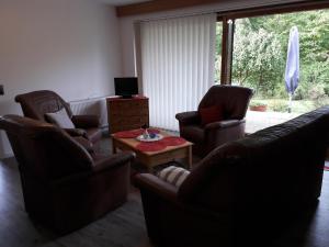 a living room with two chairs and a coffee table at Ferienhaus Biernat in Prinzenmoor