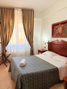 Postel nebo postele na pokoji v ubytování D'Angelo Palace Hotel