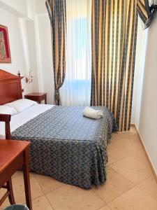 Postel nebo postele na pokoji v ubytování D'Angelo Palace Hotel