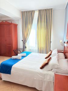 Postel nebo postele na pokoji v ubytování D'Angelo Palace Hotel
