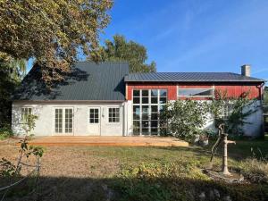 a large red and white house with a yard at Unique Spacious Home In Nature-Rich Samsø in Toftebjerg