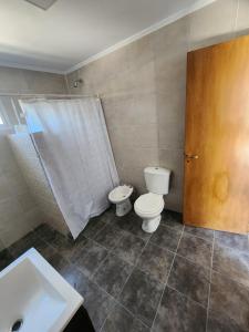 a bathroom with a toilet and a sink at Departamento Chascomus n420 in Dolores