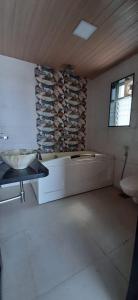 a large bathroom with a tub and a sink at Holiday Aapke Liye V Hotel in Khopoli