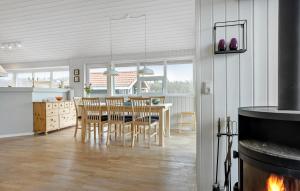 a kitchen and dining room with a table and chairs at 3 Bedroom Amazing Home In Spøttrup in Lihme