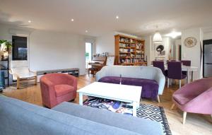 a living room with a couch and chairs and a table at 3 Bedroom Nice Home In Amfreville in Amfréville