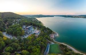 an aerial view of a lake with a tennis court at Hotel Zelená Lagúna in Domaša Dobrá