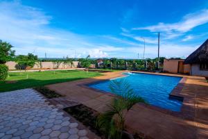 a swimming pool in the middle of a yard at Morning Mist Lodge in Livingstone