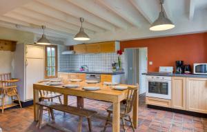 a kitchen with a wooden table and chairs in it at Stunning Home In Les Baux De Breteuil in Les Baux-de-Breteuil