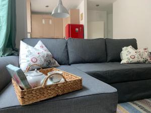 a wicker basket on a couch with a tea pot at Casa Cinzia Rosa in Eckernförde