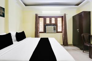 Postel nebo postele na pokoji v ubytování Super Hotel O Dwarka Metro