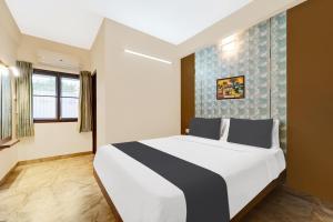 Postel nebo postele na pokoji v ubytování Super Hotel O Vilankurichi