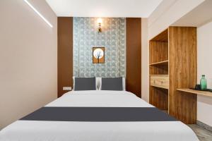 Postel nebo postele na pokoji v ubytování Super Hotel O Vilankurichi