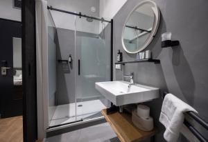 a bathroom with a sink and a shower and a mirror at "Het Wapen Van Willemstad" in Willemstad +66 photos