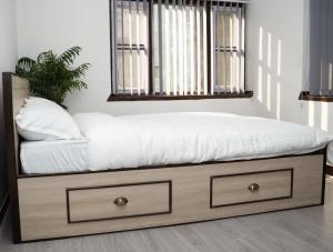 a bed with a white mattress and a window at The Serenity Space in Pātan