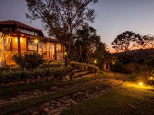 a house at night with lights in front of it at Pousada Spa Prana Lorien in Santo Antônio do Leite