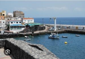 a harbor with boats in the water next to a city at Casa Fede Los Abrigos in Los Abrigos