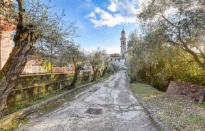 an old road with a clock tower in the distance at Nice Home In San Salvatore With Wifi in San Salvatore