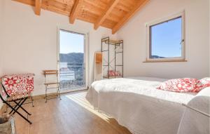 a bedroom with a bed and a large window at Nice Home In San Salvatore With Wifi in San Salvatore