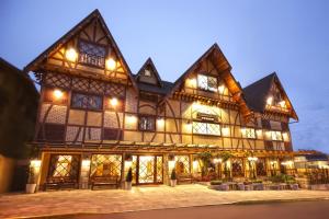 a large building with many windows and lights at Life Hotel Infinity in Gramado
