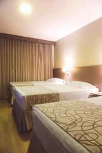 a hotel room with two beds in a room at Transamerica Fit Catalão in Catalão +37 photos