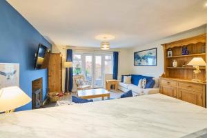 a bedroom with a bed and a living room at Host & Stay - Kittling Nook in Bamburgh +18 photos