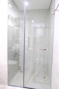 a shower with a glass door in a bathroom at Homestay Masteri in Gia Lâm Pho +17 photos