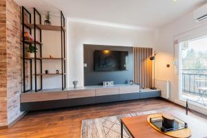 a living room with a tv on a wall at Flexible SelfCheckIns 122 - Zagreb - Bedroom - Loggia in Zagreb