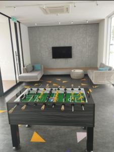 a living room with a table with hockey equipment on it at The Luxe Lodge 2BR Apartment Southville City Bangi in Bangi