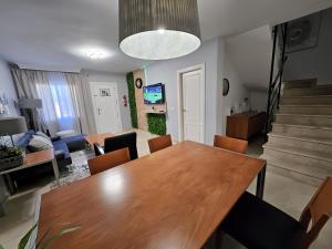 a dining room and living room with a table and chairs at Chalet with Sea Views in Fuengirola