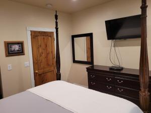 a bedroom with a bed and a dresser with a television at Newly remodeled mountain home! in Floriston
