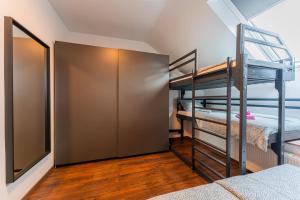 a bunk room with two bunk beds and a mirror at Flexible SelfCheckIns 122 - Zagreb - Bedroom - Loggia in Zagreb