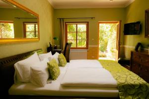 a bedroom with a large bed with yellow walls at THE GATE GARDEN Hotel in Berlin