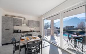 a kitchen with a table and chairs and a balcony at Residence Villa Argentea in Gravedona
