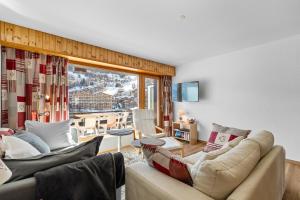 a living room with two couches and a large window at Rossignol C3 - 4 pers - vue magnifique in Nendaz