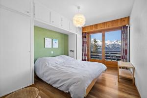 a bedroom with a bed and a window with a view at Rossignol C3 - 4 pers - vue magnifique in Nendaz